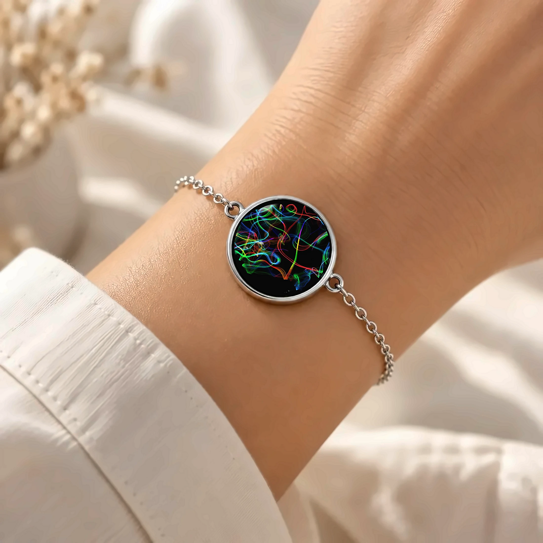 La même œuvre sous verre, sur un bracelet porté au poignet.